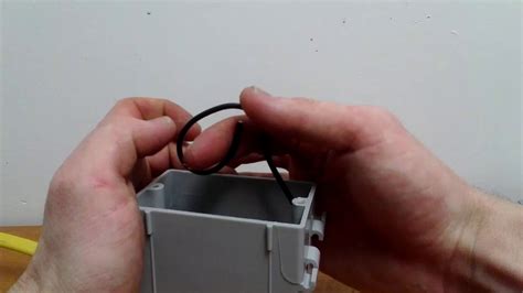 folding wires into an electrical box|packing wire into device box.